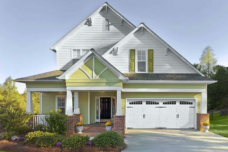 House with garage door with carriage house bead board panels